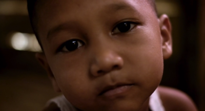 young Sumatran boy thinking about the future of orangutans