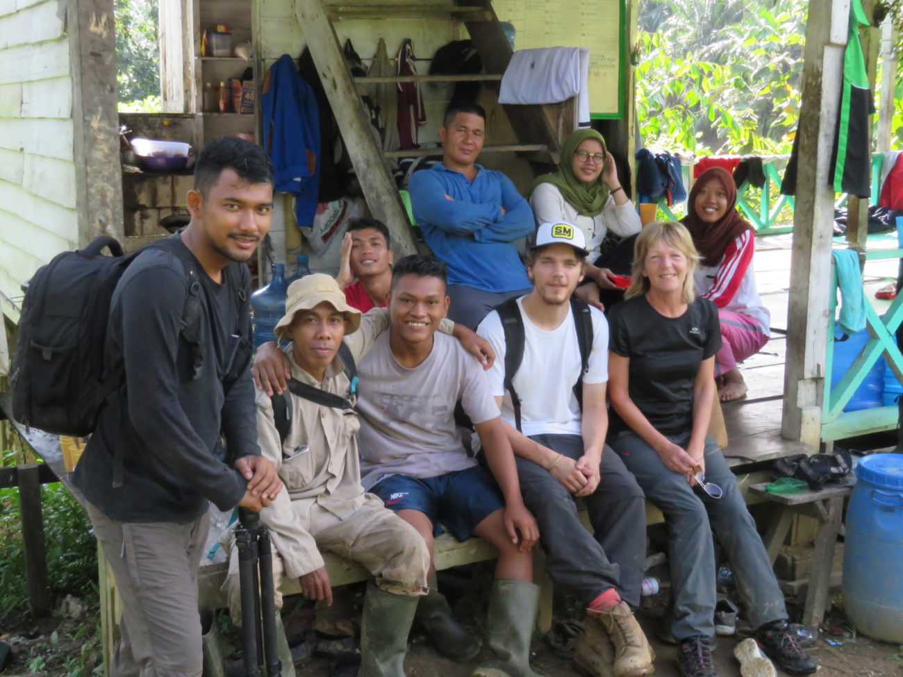 A group of people sitting outdoors 