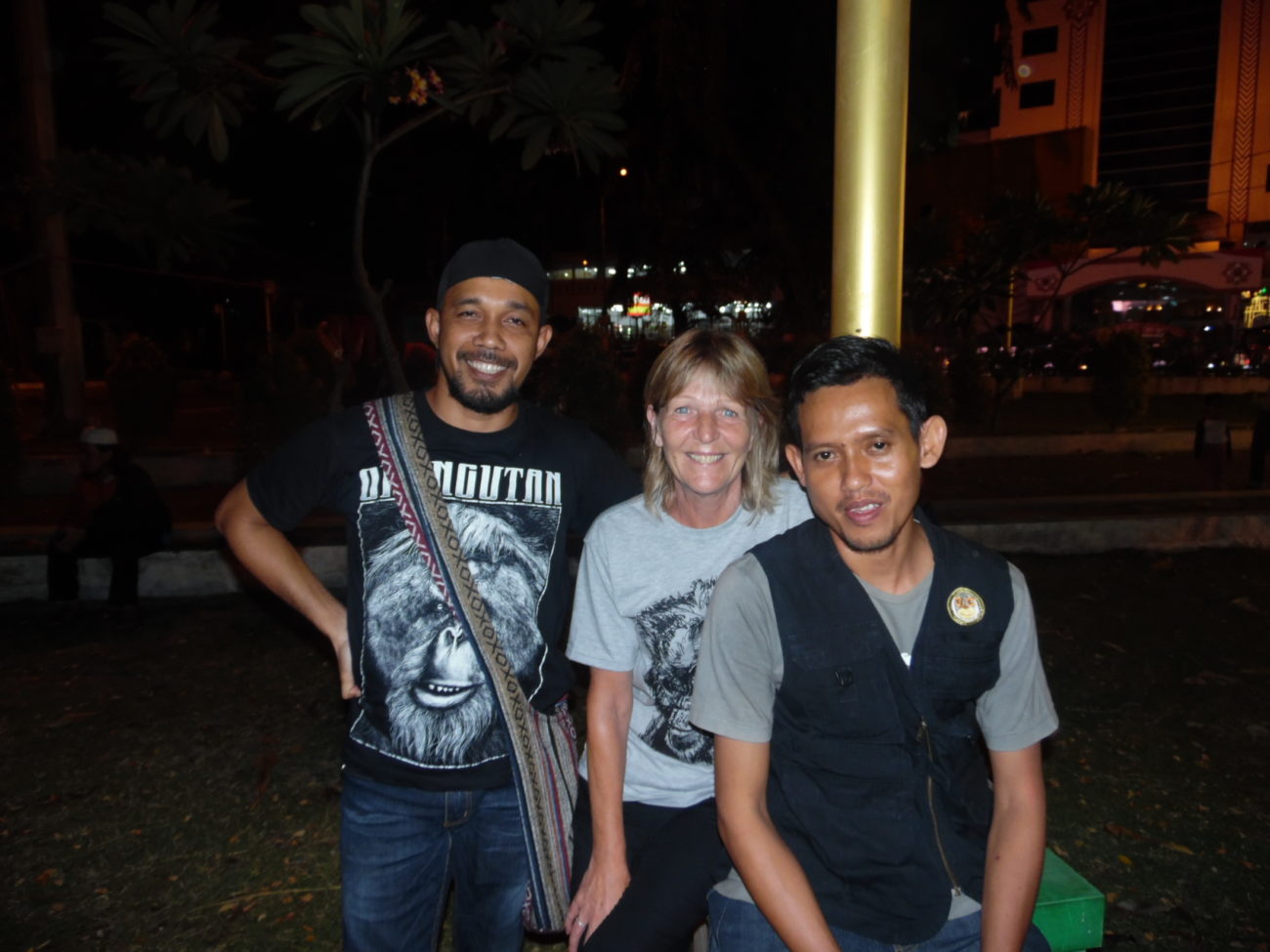 Three people standing together smiling