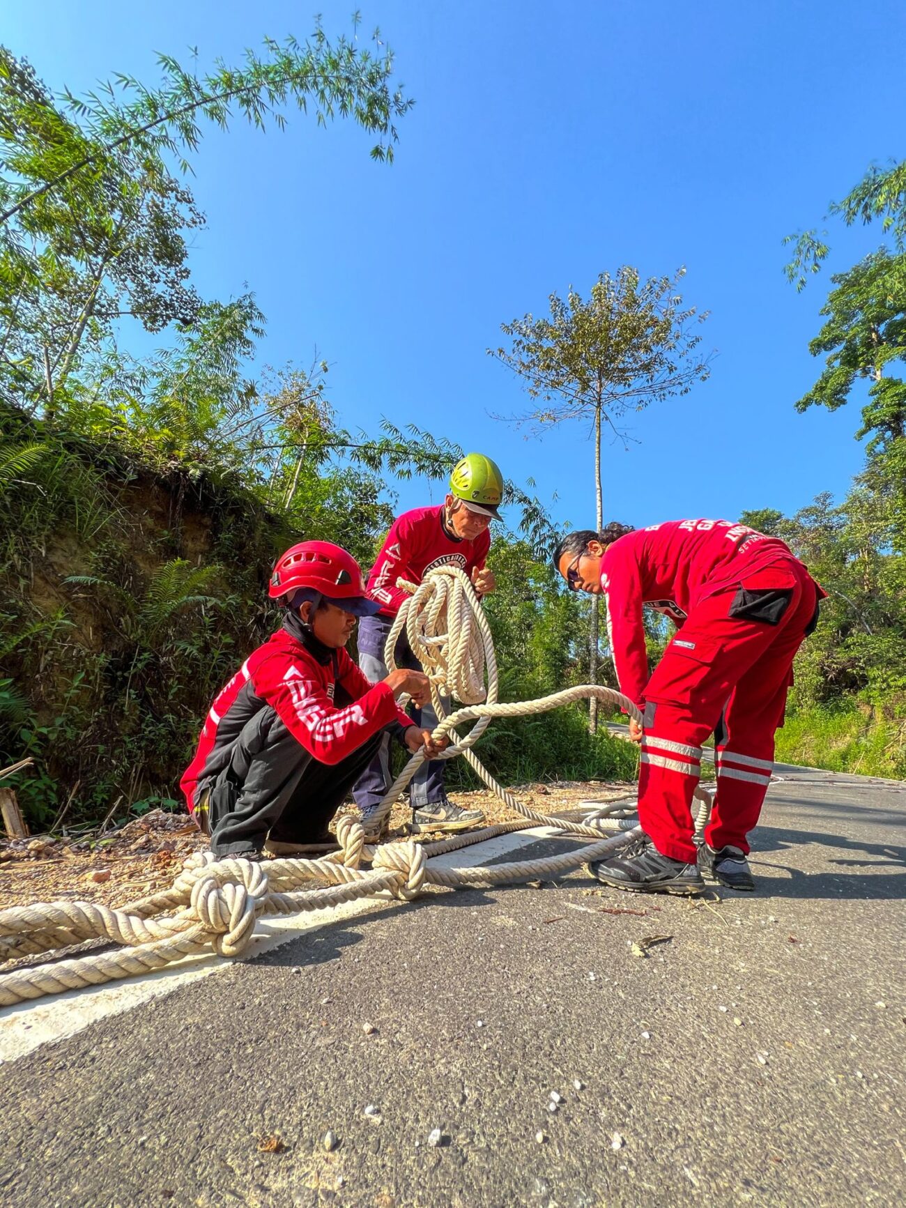 Members of Vertical Rescue Indonesia prepare ropes on the roadside