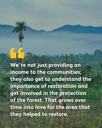 A landscape image of a farm set against fog and mountains. The text reads: We’re not just providing an income to the communities; they also get to understand the importance of restoration and get involved in the protection of the forest. That grows over time into love for the area that they helped to restore.