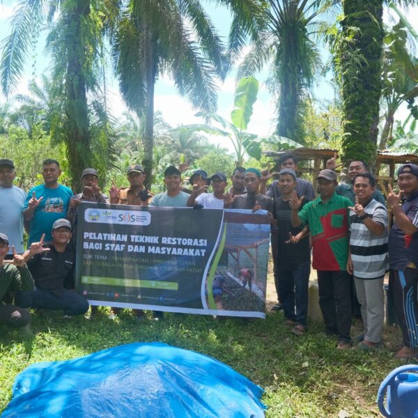 PETAI holds up a sign alongside training participants
