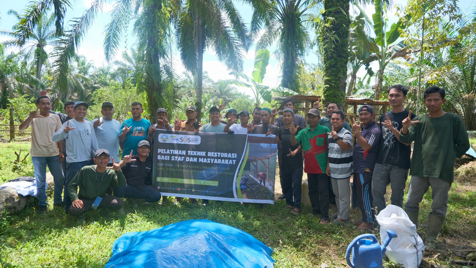 PETAI holds up a sign alongside training participants